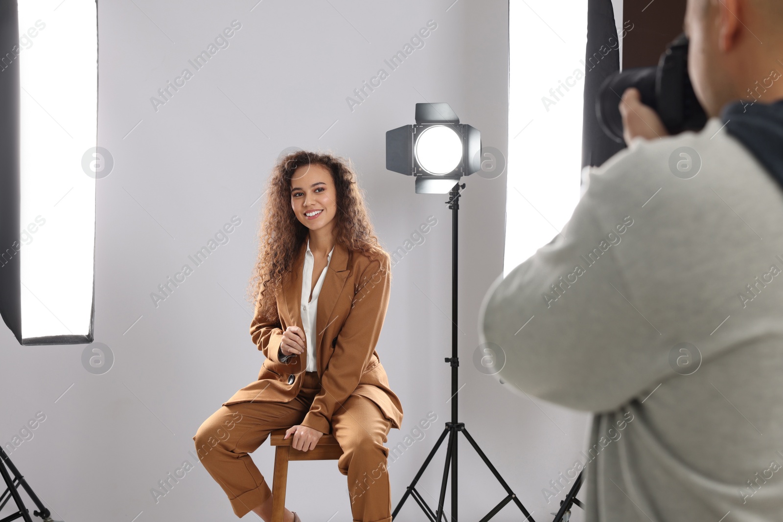 Photo of Beautiful African American model posing for professional photographer in studio