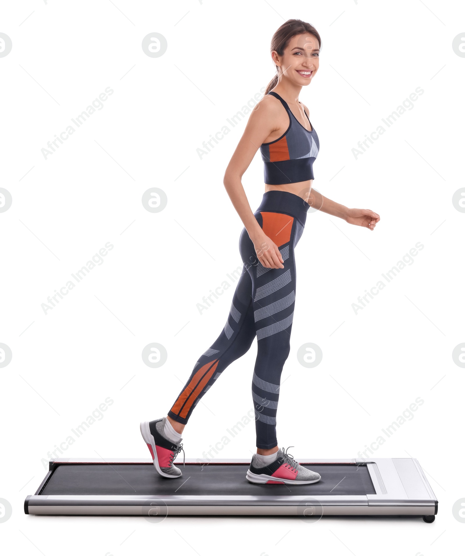 Photo of Sporty woman using walking treadmill on white background