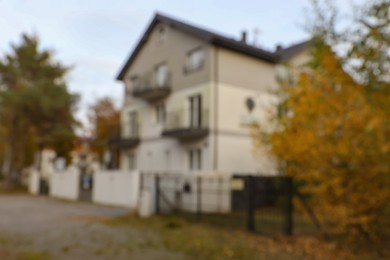 Photo of Blurred view of beautiful light gray house outdoors. Real estate