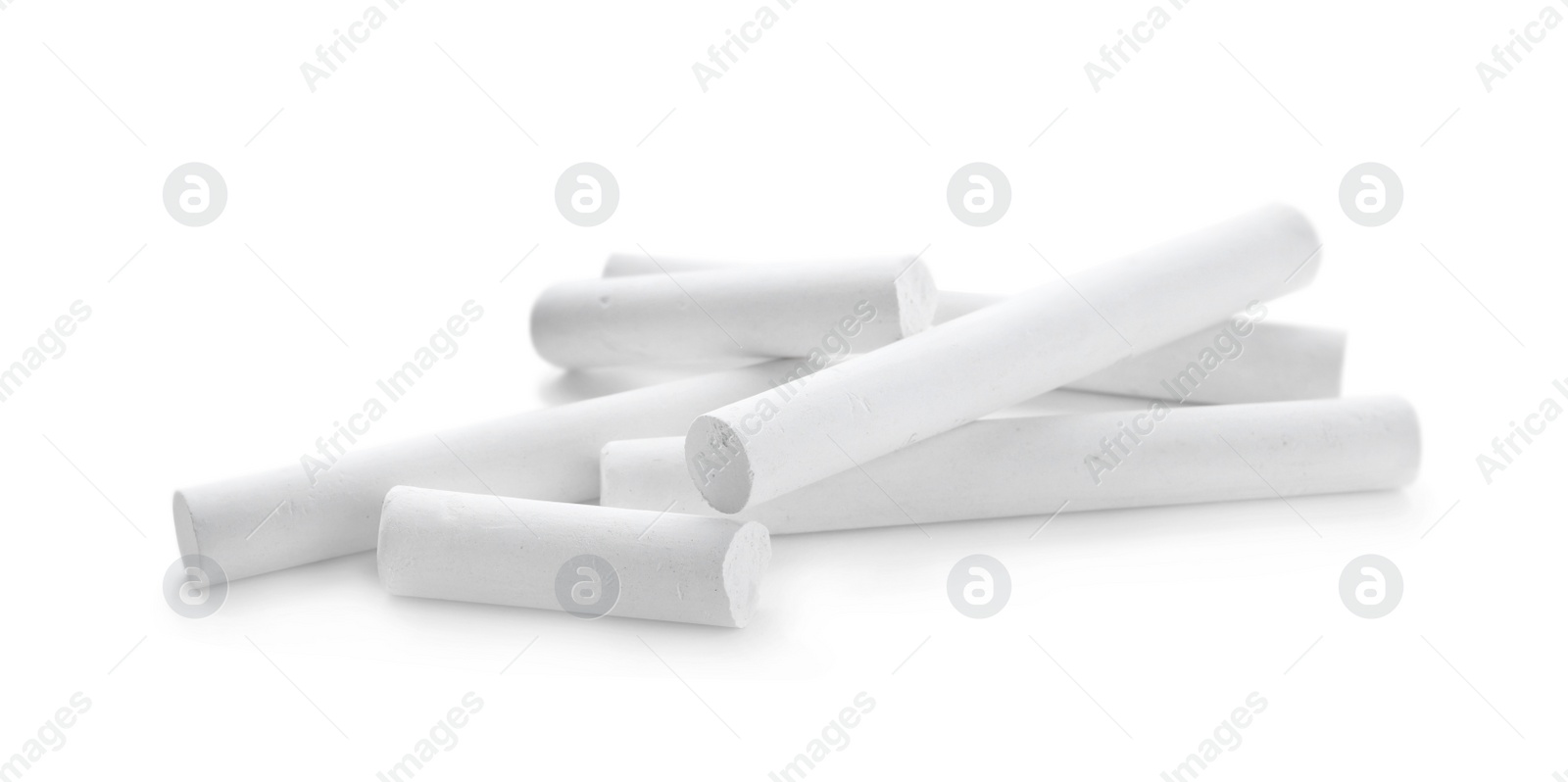 Photo of Small pieces of chalk on white background