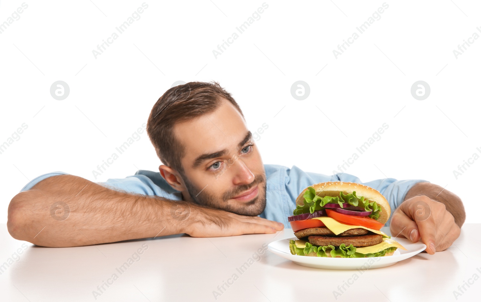 Photo of Young man with tasty burger on white background