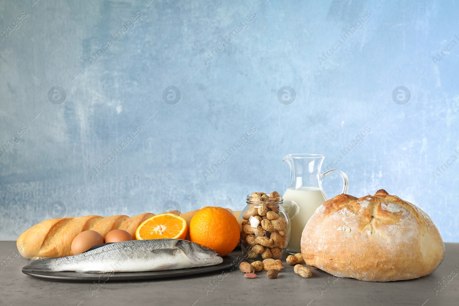 Photo of Set of natural products on table against light blue background, space for text. Food allergy