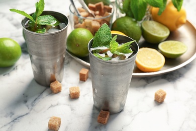 Photo of Composition with delicious mint julep cocktail on table