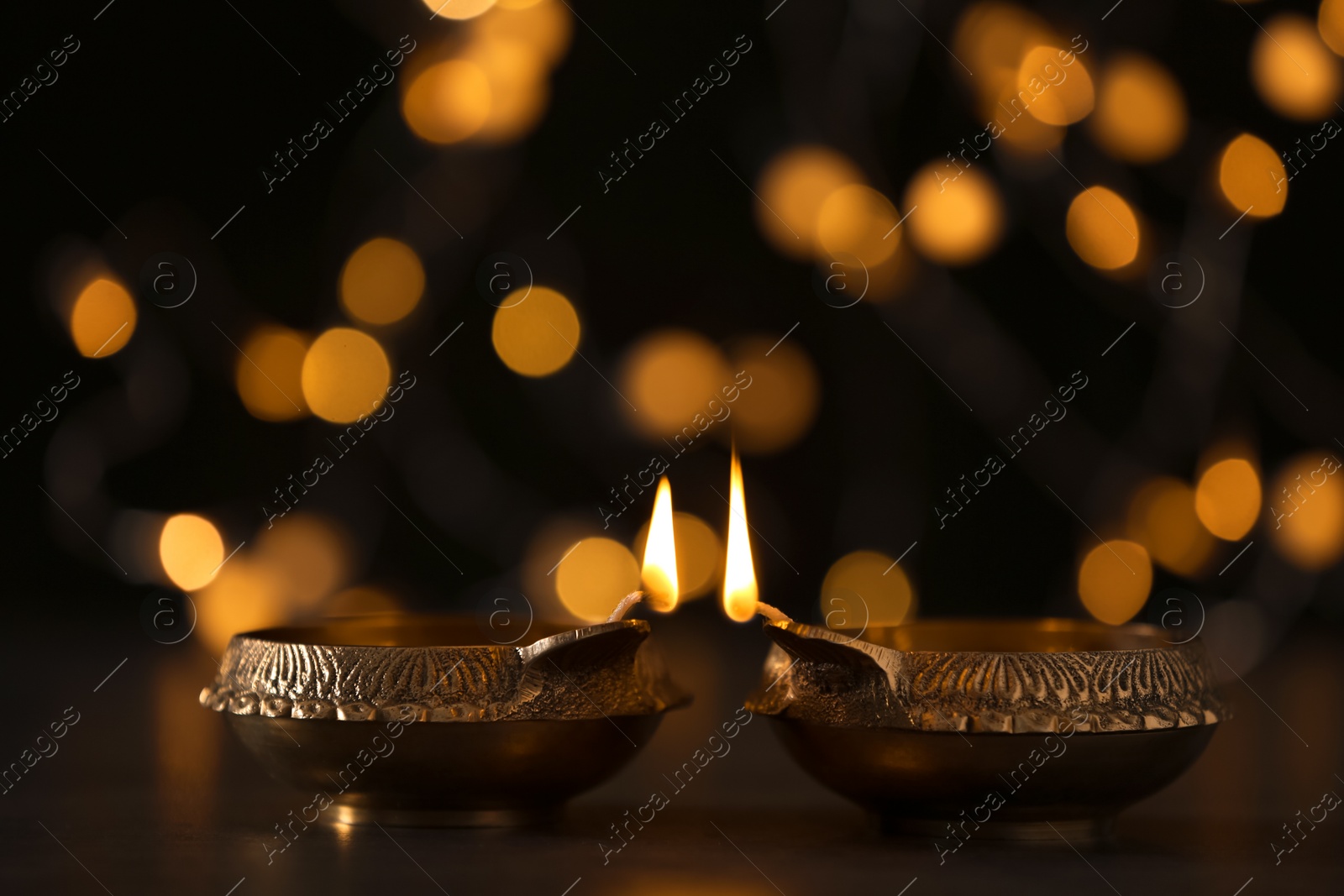 Photo of Diwali diyas or clay lamp against blurred lights