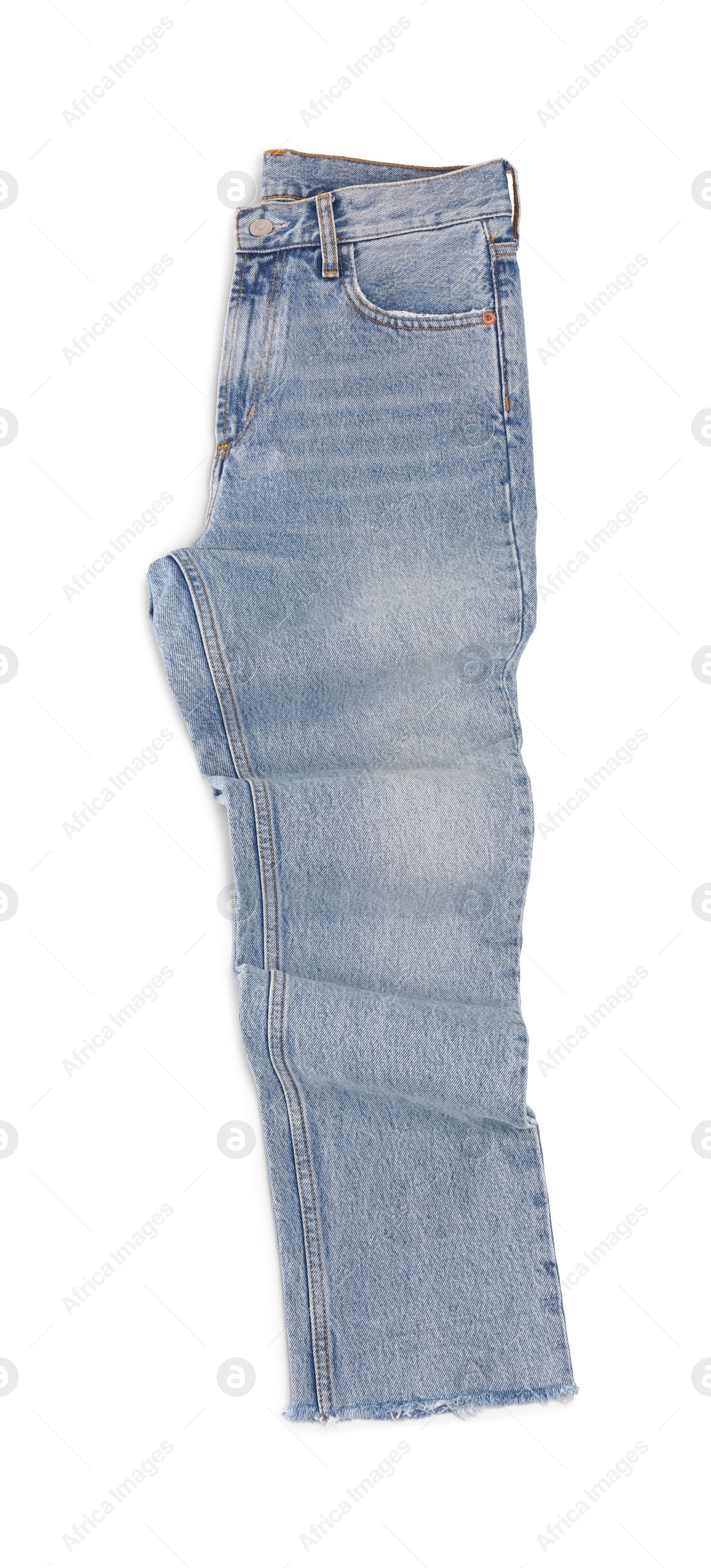 Photo of Rumpled light blue jeans isolated on white, top view. Stylish clothes