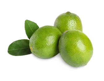 Photo of Fresh ripe limes with green leaves isolated on white