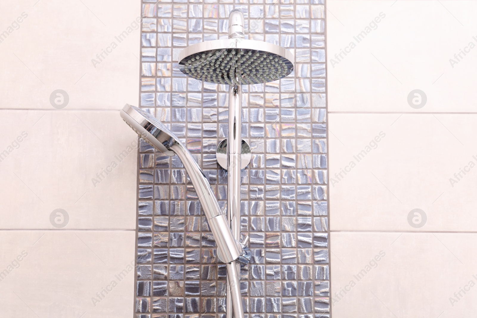 Photo of Shower heads on tiled wall in bathroom