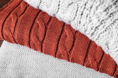 Stack of folded warm sweaters, closeup view