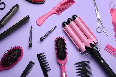 Photo of Flat lay composition of different professional hairdresser tools on lilac background