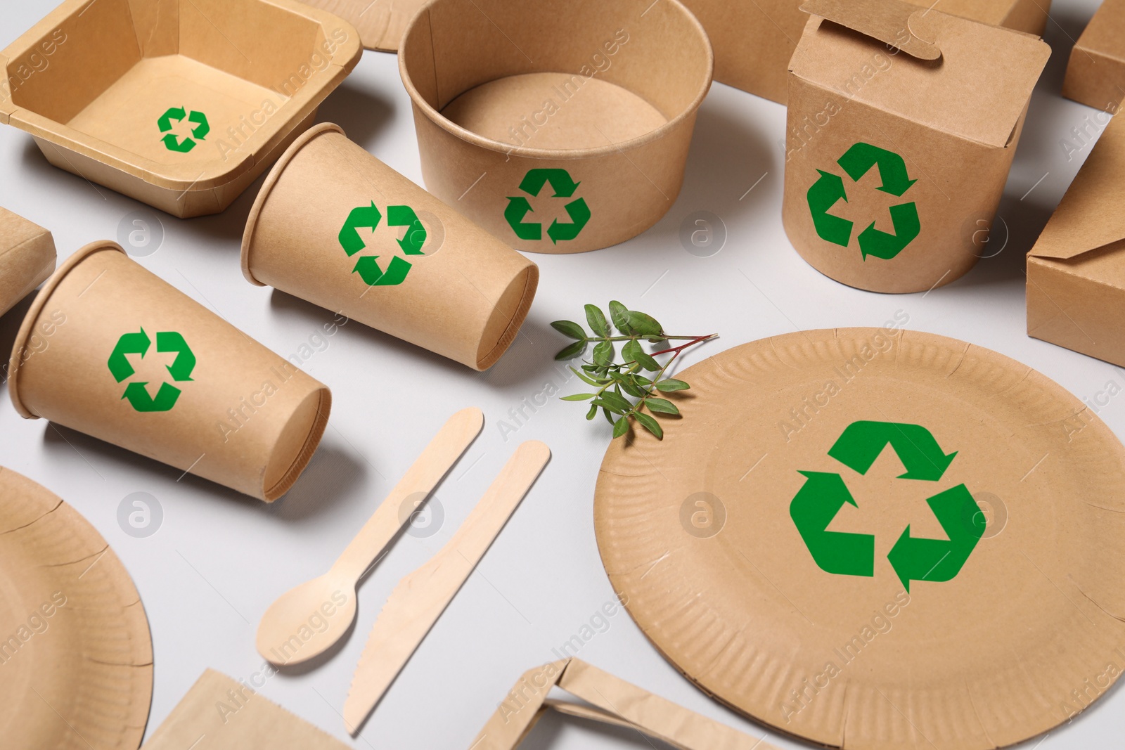 Image of Set of eco friendly food packaging with recycling symbols on light background