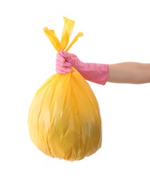 Photo of Woman holding plastic bag full of garbage on white background, closeup