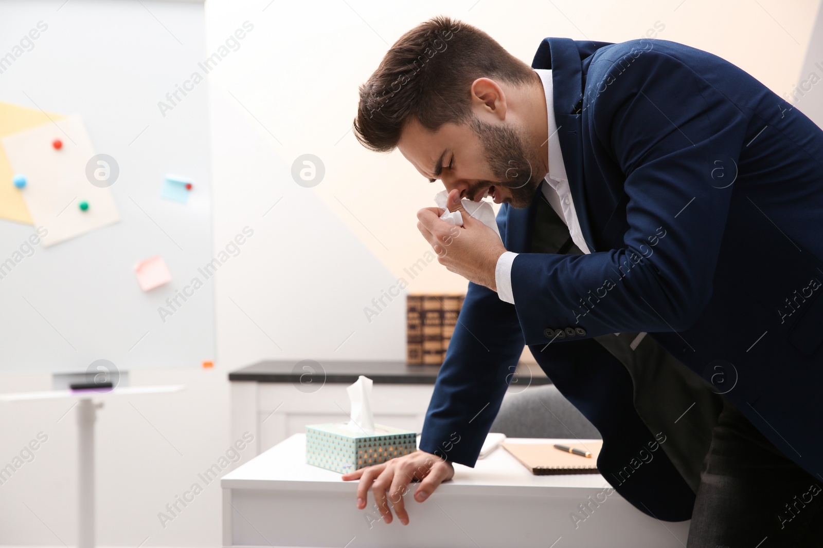 Photo of Sick young man at workplace. Influenza virus