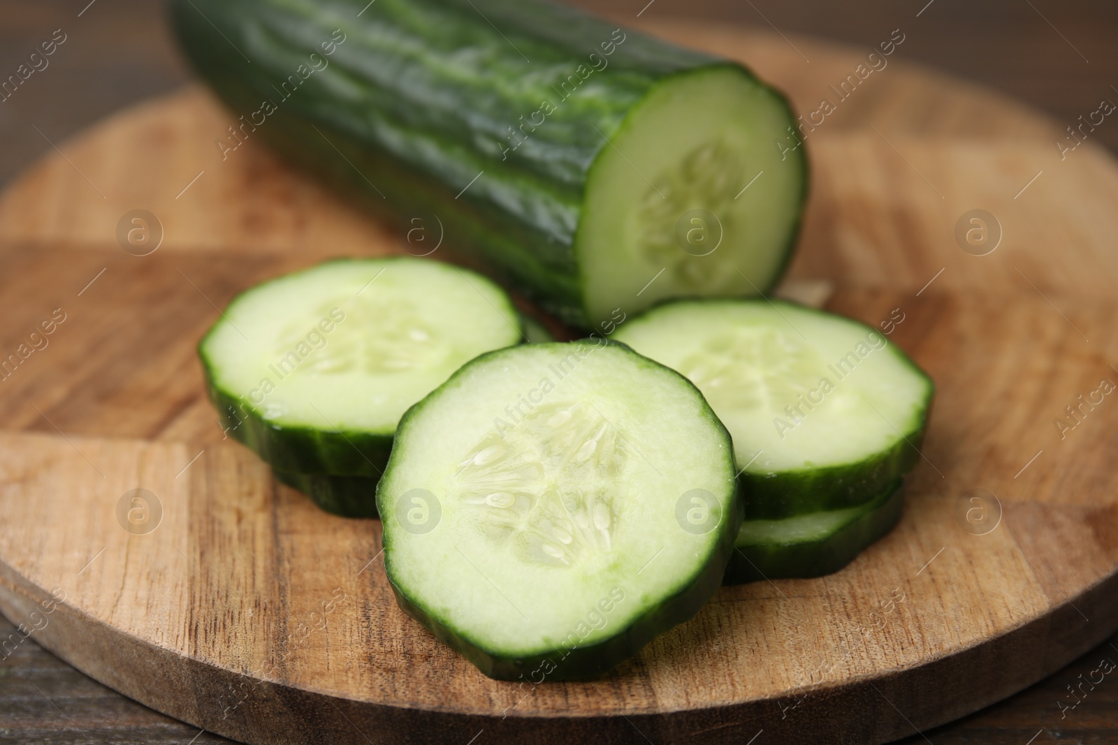 Photo of Fresh cut cucumber on wooden table, closeup