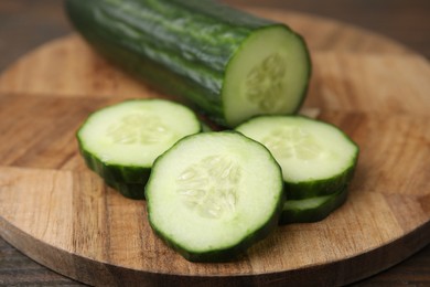 Fresh cut cucumber on wooden table, closeup