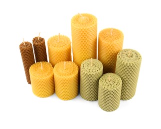 Photo of Stylish elegant beeswax candles isolated on white