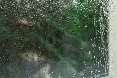 Photo of Window glass with water drops as background, closeup