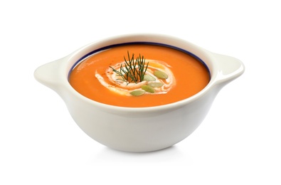 Tasty creamy pumpkin soup with dill and seeds in bowl on white background