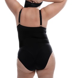 Photo of Back view of overweight woman in black underwear on white background, closeup. Plus-size model