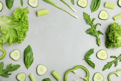 Flat lay composition with fresh salad ingredients on grey background, space for text