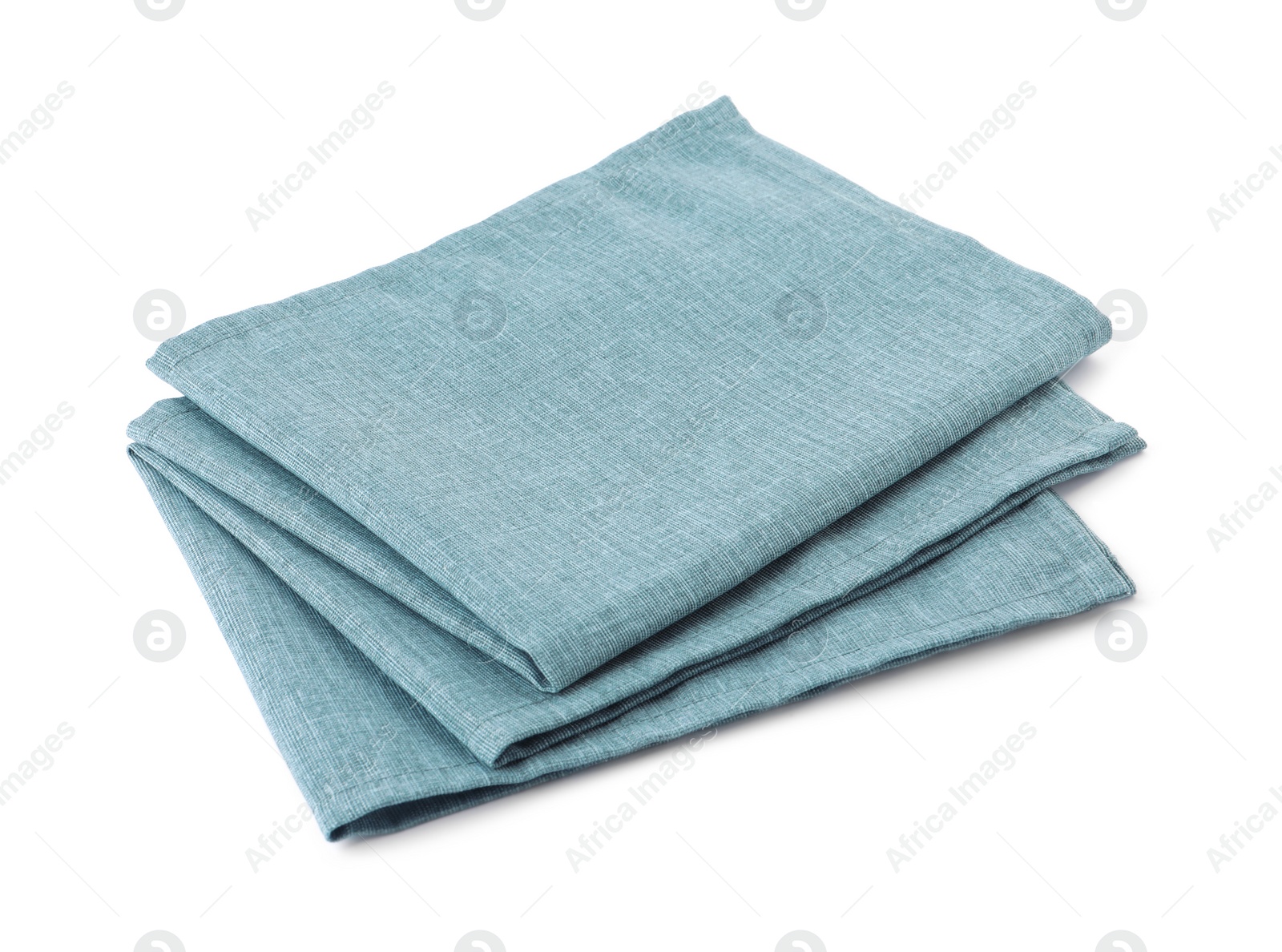 Photo of New clean light blue cloth napkins isolated on white