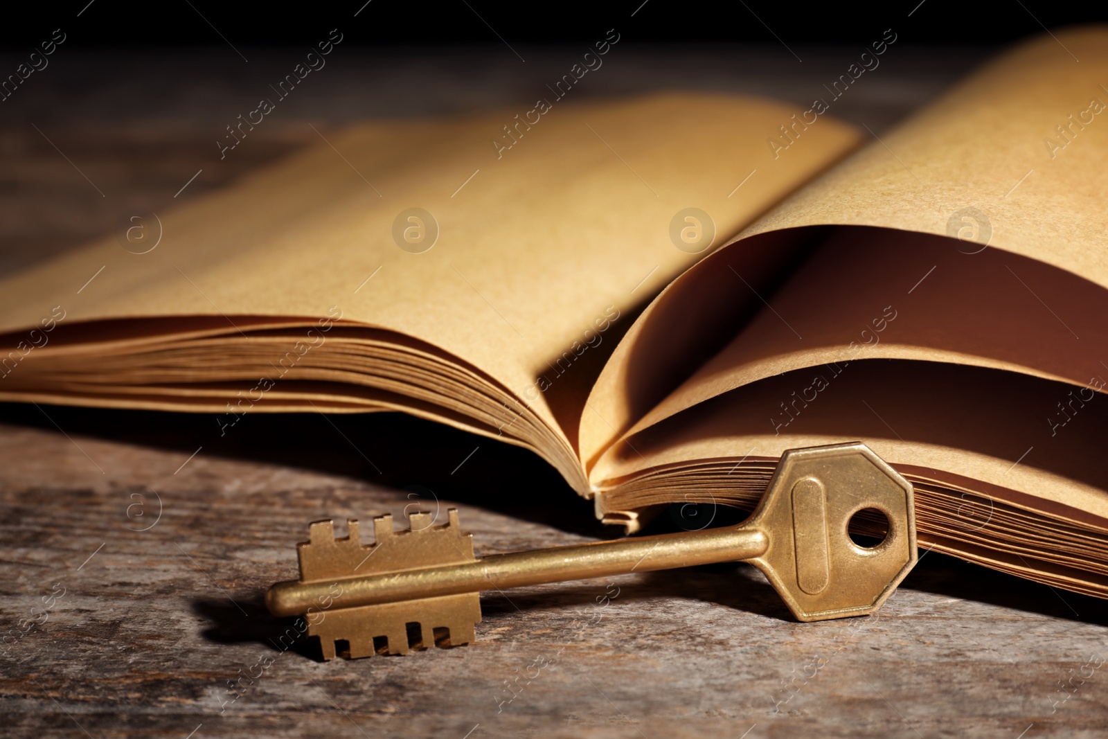 Photo of Old vintage key with book on wooden table