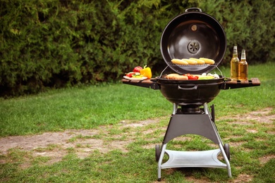 Photo of Barbecue grill with tasty fresh food outdoors