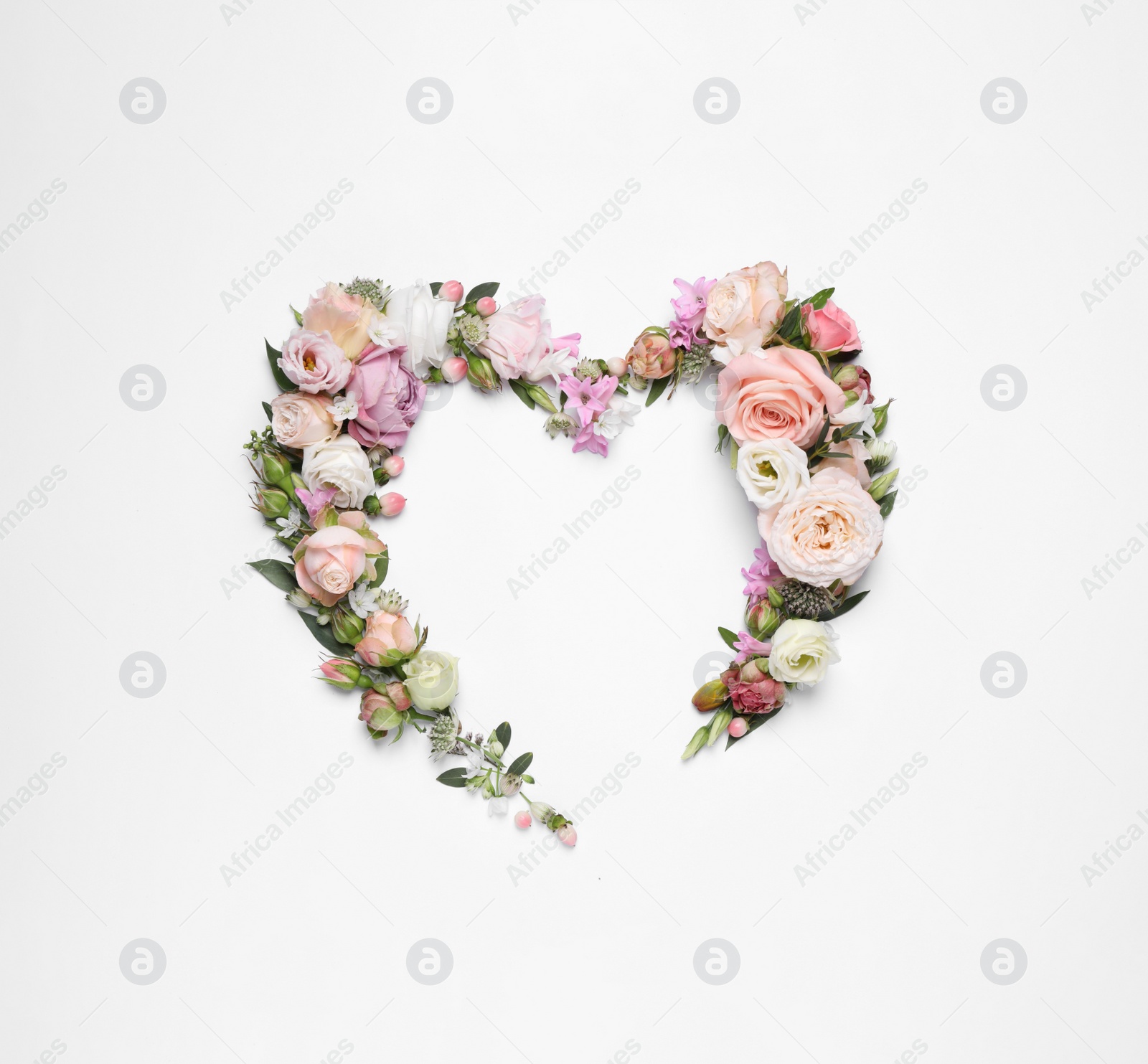 Photo of Beautiful heart made of different flowers on white background, top view