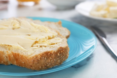 Photo of Fresh bread with tasty butter on plate