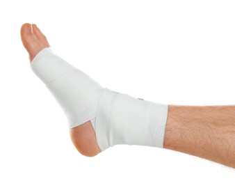 Photo of Man with foot wrapped in medical bandage on white background, closeup