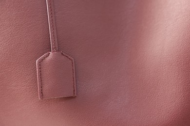 Photo of Texture of leather and tag as background, closeup view