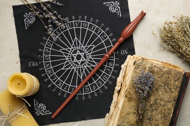 Photo of Flat lay composition with magic wand and divination cloth on light textured background