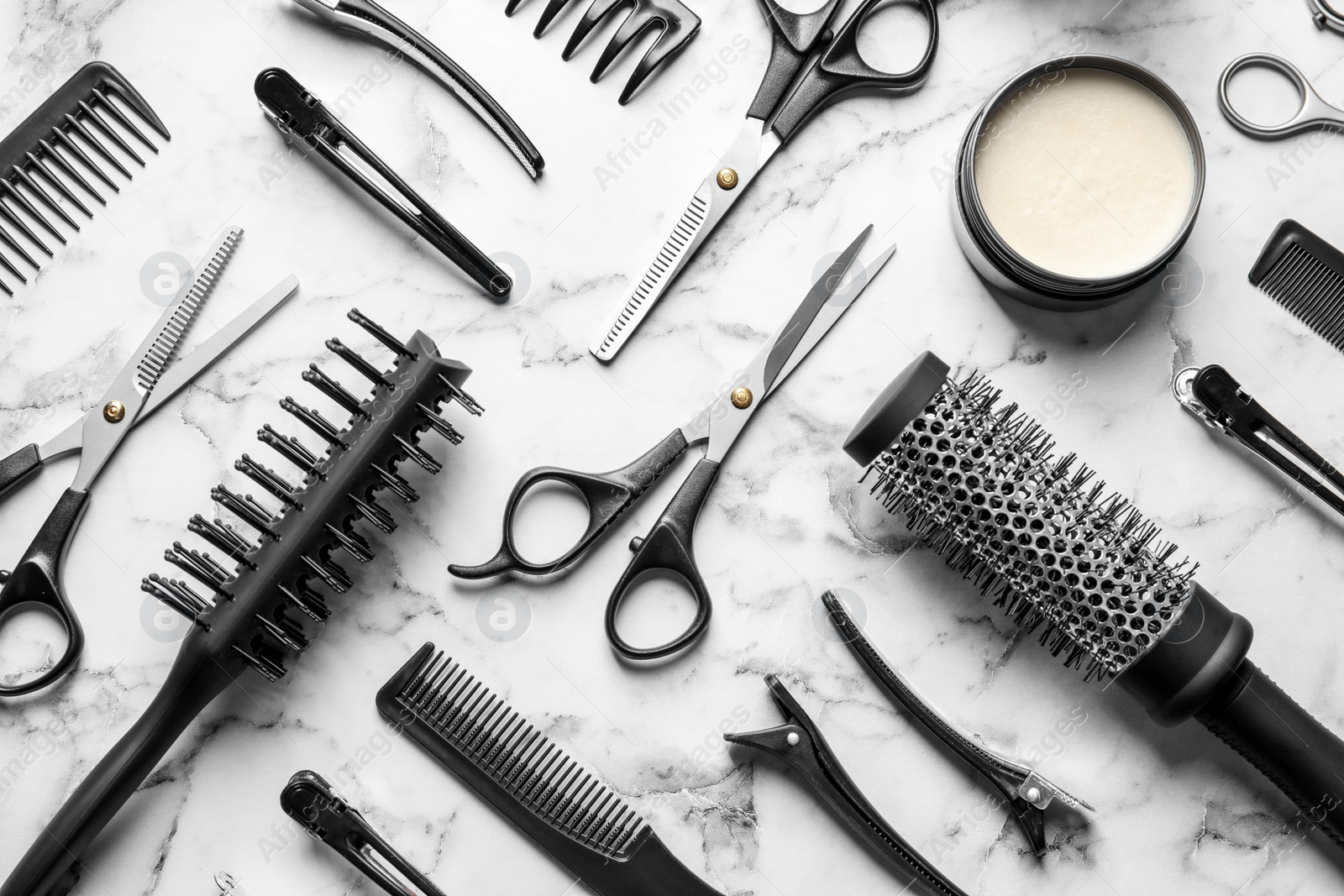 Photo of Flat lay composition with scissors and other hairdresser's accessories on white marble background