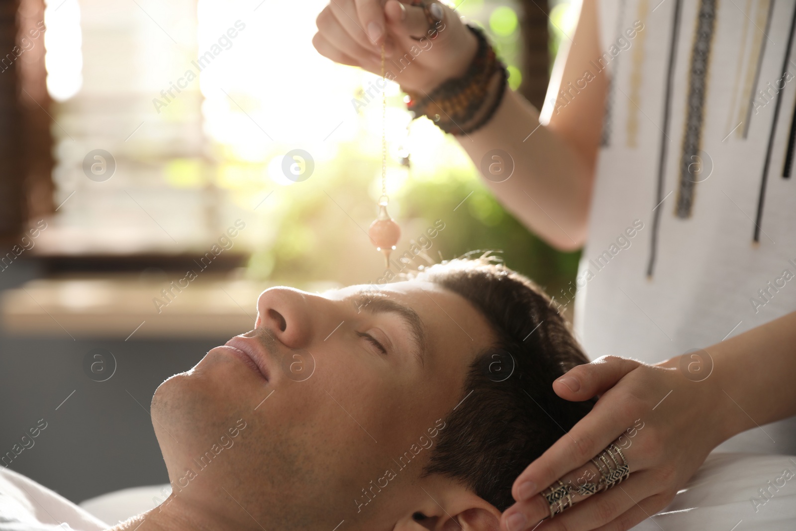 Photo of Man during healing session in therapy room