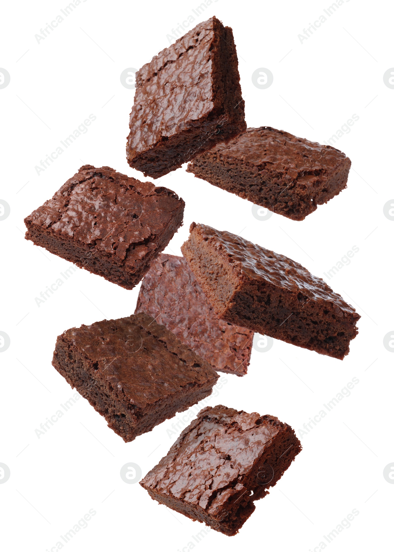 Image of Slices of delicious chocolate brownie flying on white background