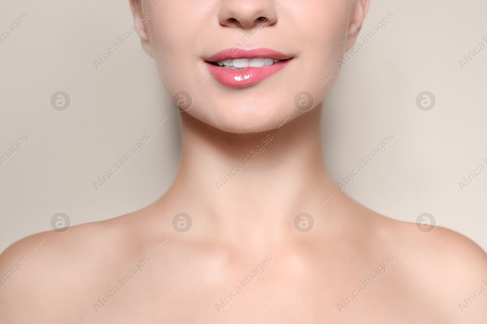 Photo of Beautiful young woman with perfect lips makeup on light background, closeup