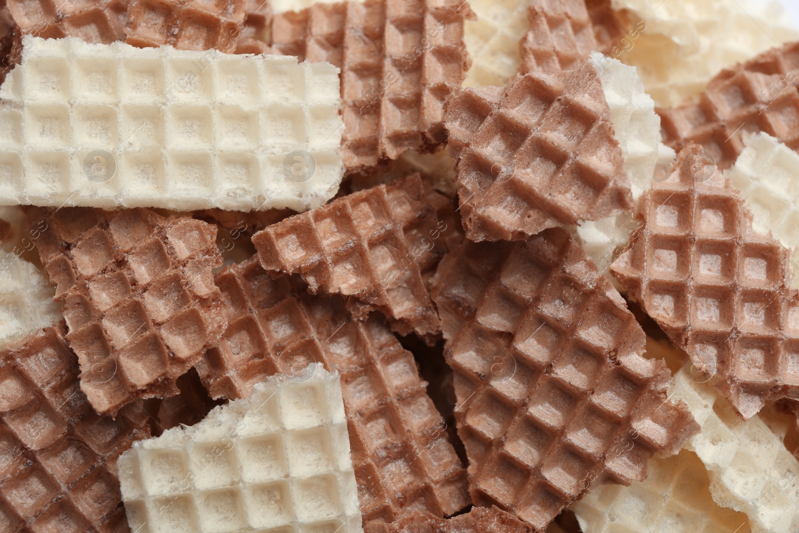 Photo of Tasty crumbled wafers as background, top view. Crispy food