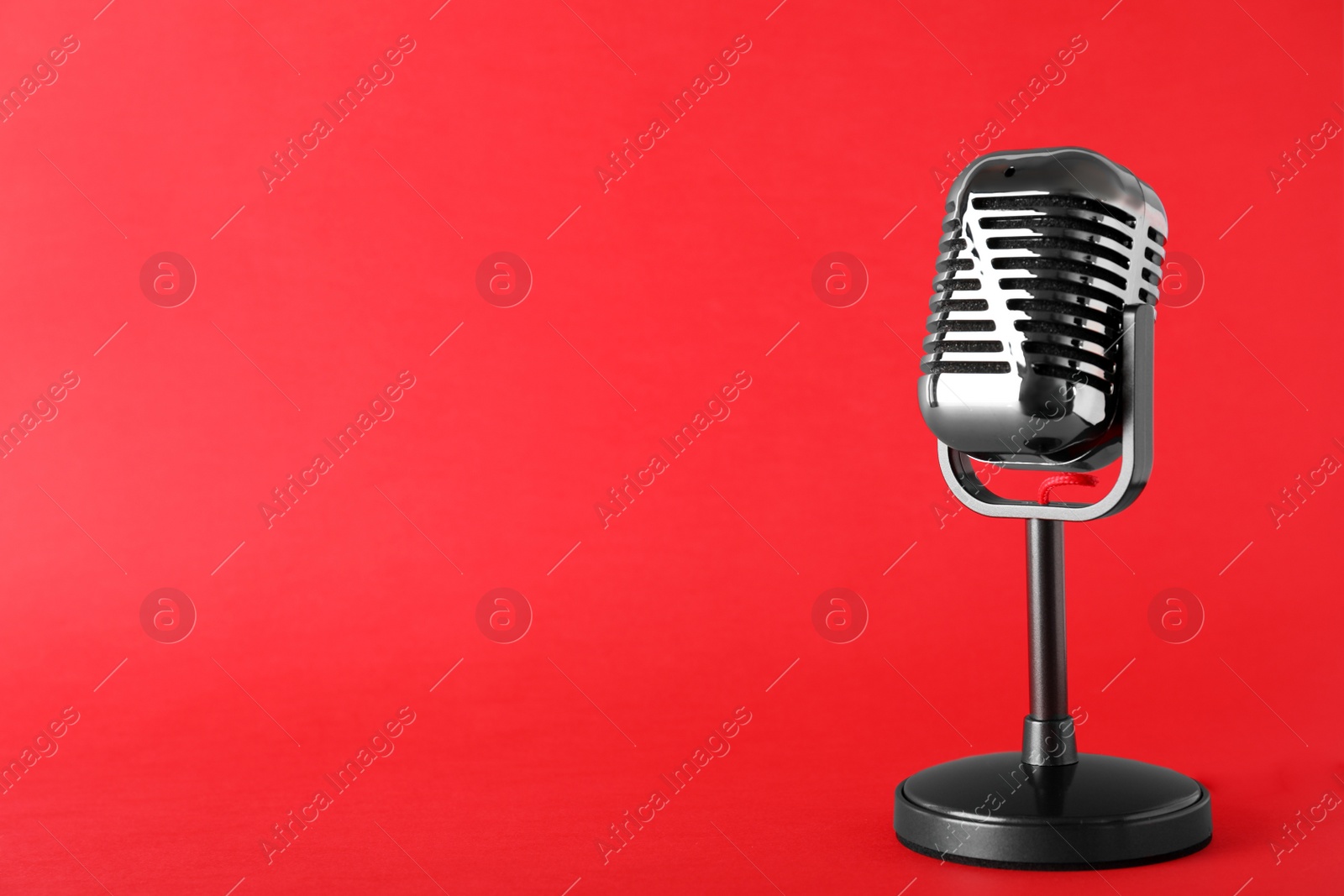 Photo of Retro microphone on color background, space for text