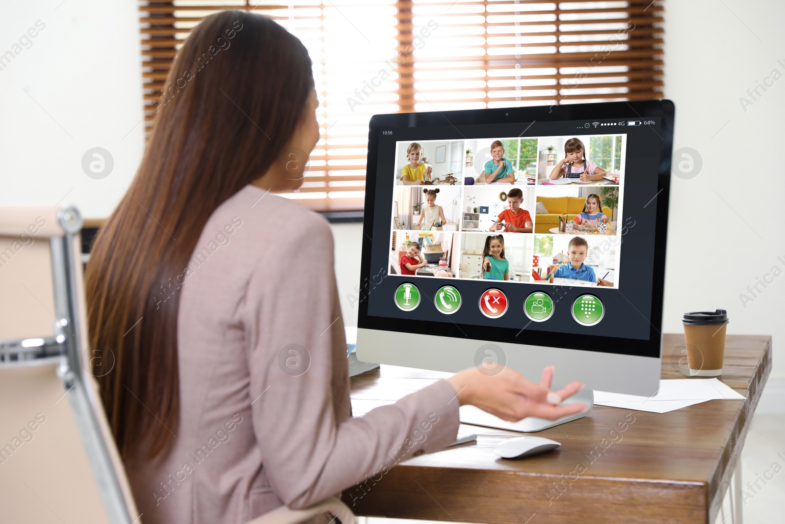 Image of Teacher giving online school lesson during quarantine and social distancing due to Covid-19 pandemic. Pupils studying at home via video conference