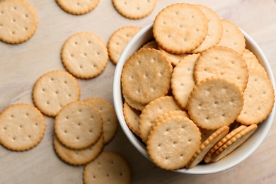 Delicious crispy crackers on table, flat lay