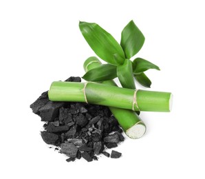 Photo of Fresh bamboo and charcoal on white background