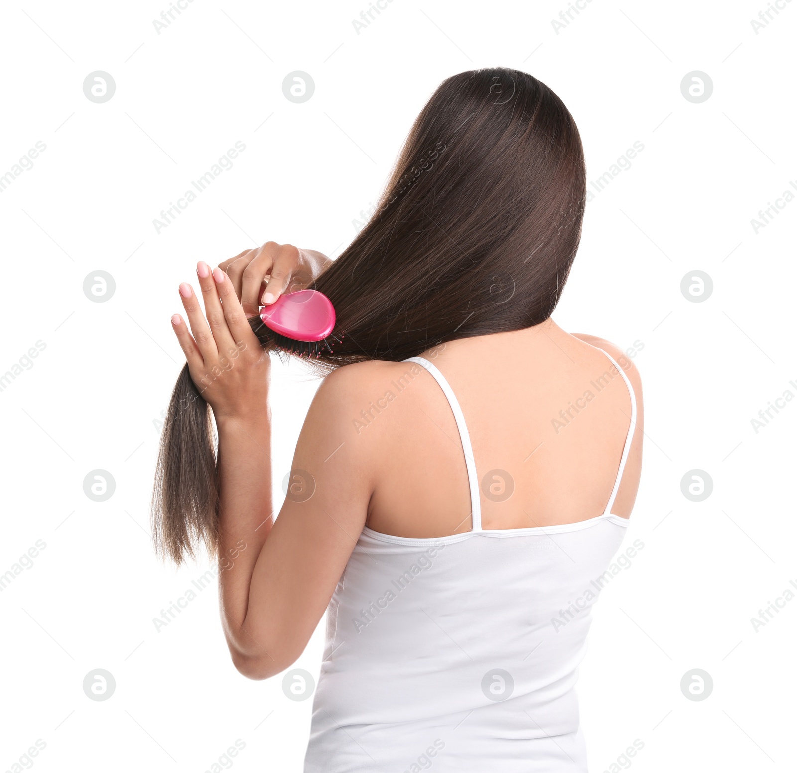 Photo of Back view of young woman with hair brush on white background