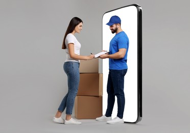 Courier delivering parcels to woman near huge smartphone on grey background