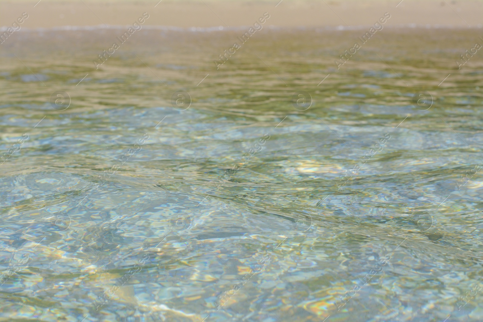 Photo of Beautiful sea water with ripples and sandy shore