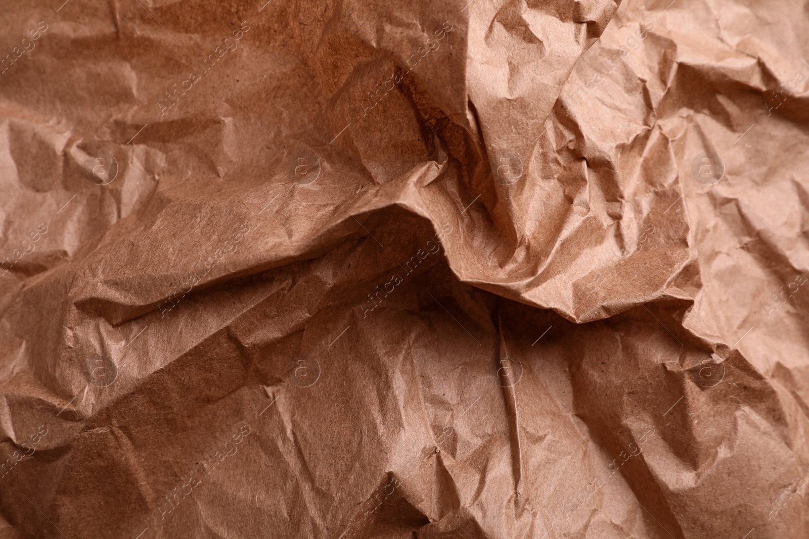 Photo of Texture of wrinkled kraft paper bag as background, closeup