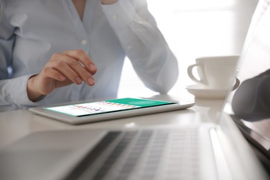 Image of Woman using modern tablet with switched on VPN at table in office, closeup