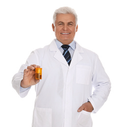 Photo of Senior pharmacist with pills on white background