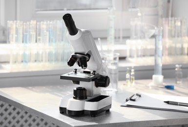 Photo of Modern medical microscope on table in laboratory