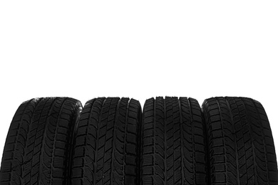 Set of new winter tires on white background, closeup