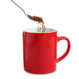 Pouring aromatic instant coffee into red cup on white background