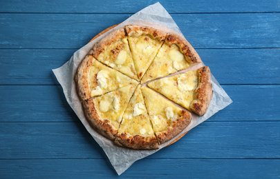 Photo of Tasty cheese pizza on blue wooden table, top view